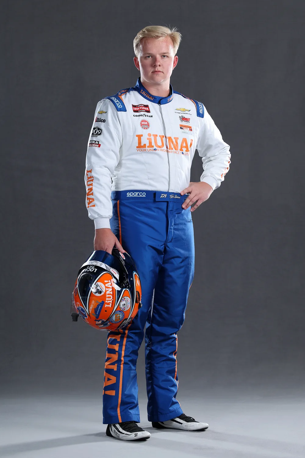 Tyler Ankrum in his LIUNA firesuit, holding his helmet